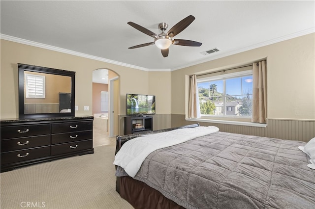 bedroom featuring light colored carpet, arched walkways, visible vents, and crown molding