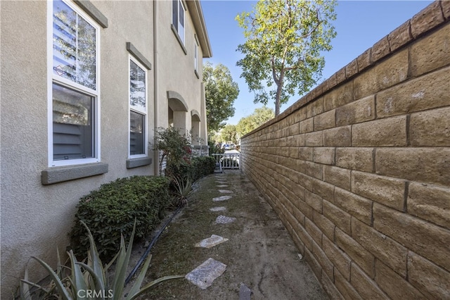 view of home's exterior featuring fence and stucco siding