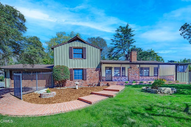 tri-level home featuring brick siding, a chimney, board and batten siding, a front yard, and driveway