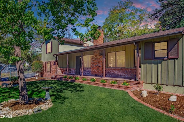 5028 El Adobe Ln, La Crescenta, CA 91214 - tri-level home with brick siding, a lawn, a chimney, and board and batten siding