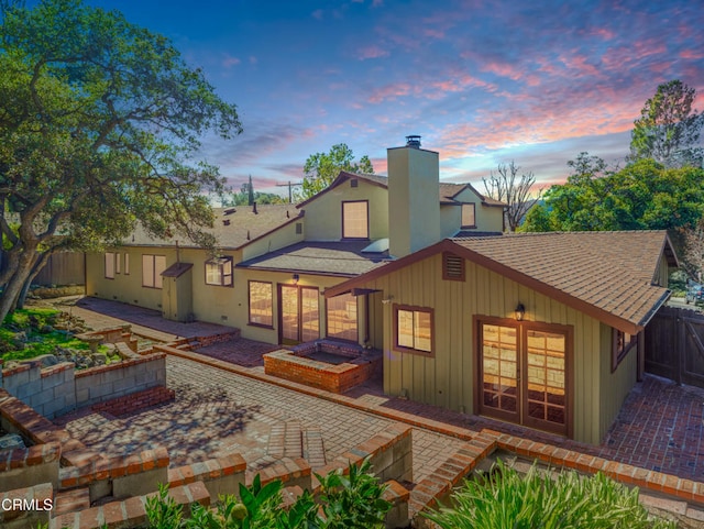5028 El Adobe Ln, La Crescenta, CA 91214 - rear view of house featuring a shingled roof, a patio area, a chimney, a fenced backyard, and board and batten siding