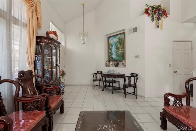 dining space with high vaulted ceiling, visible vents, and light tile patterned floors