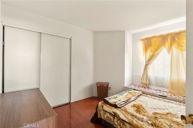 bedroom with a closet and wood finished floors