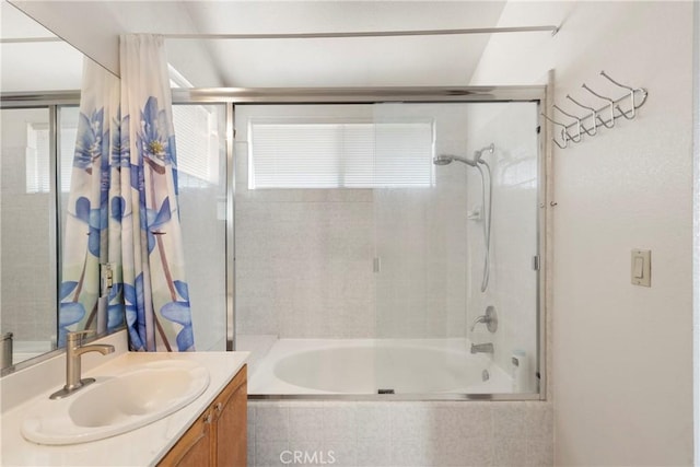 full bathroom featuring tiled shower / bath combo, plenty of natural light, and vanity