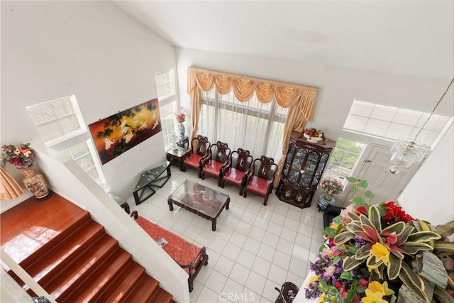 tiled living room featuring high vaulted ceiling