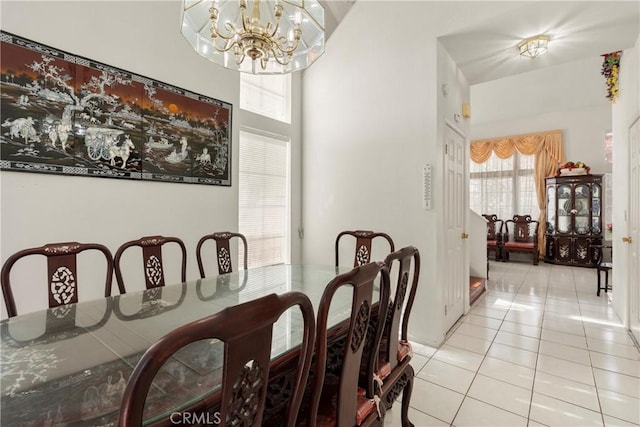 dining area with a notable chandelier and tile patterned floors