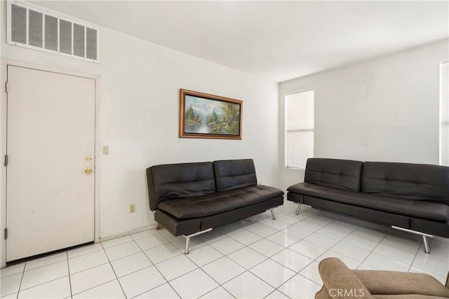 living room featuring light tile patterned floors and visible vents