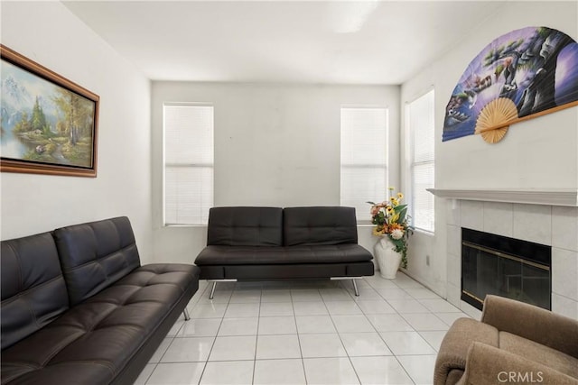 living area with a tile fireplace and light tile patterned flooring