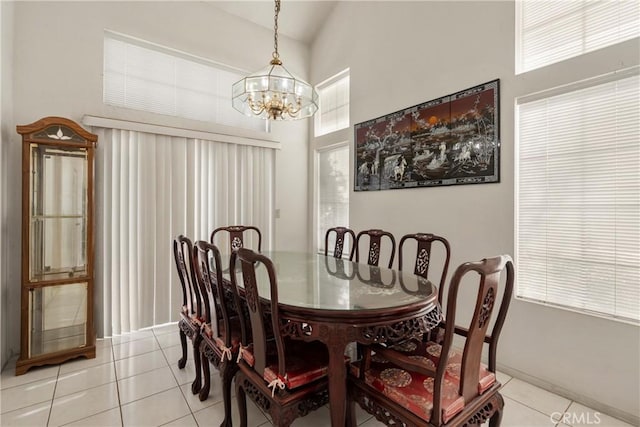 dining area featuring high vaulted ceiling, an inviting chandelier, and light tile patterned floors