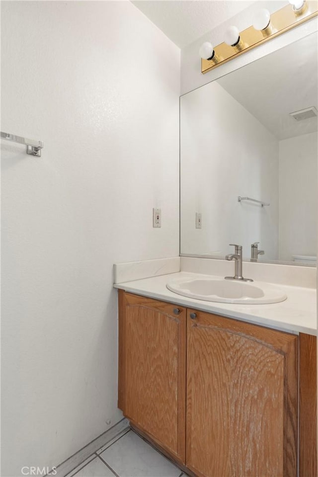 bathroom featuring tile patterned flooring, visible vents, and vanity