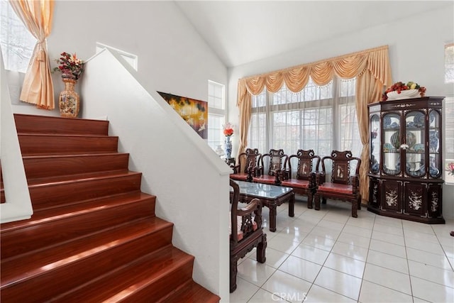 staircase featuring lofted ceiling and tile patterned floors