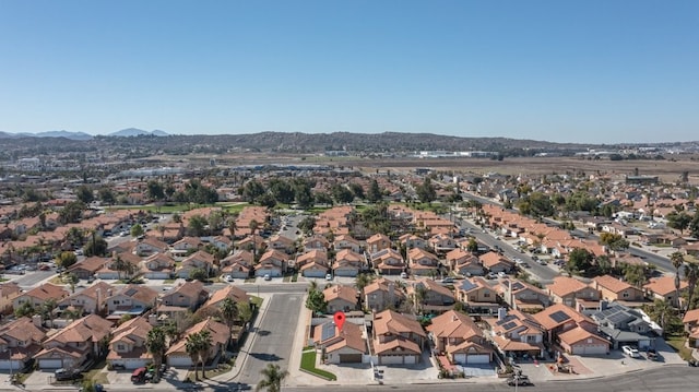 drone / aerial view featuring a residential view and a mountain view