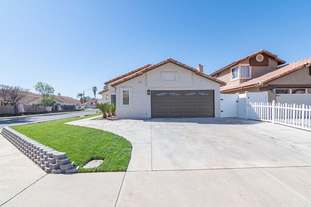 mediterranean / spanish home featuring a garage, driveway, fence, and stucco siding