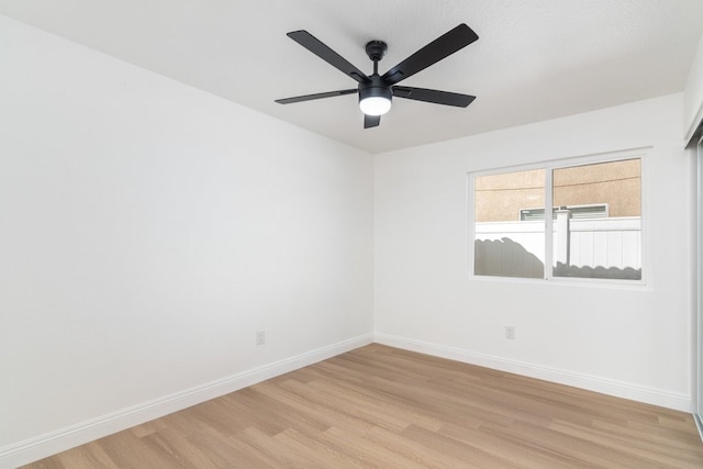 empty room with light wood-type flooring, ceiling fan, and baseboards