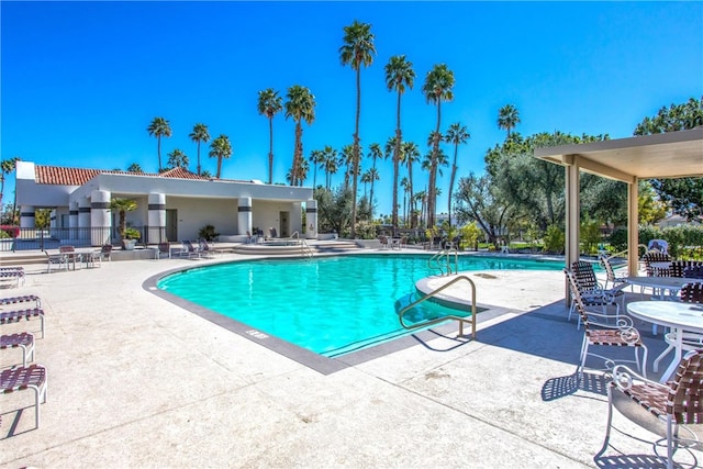 pool featuring a patio and fence