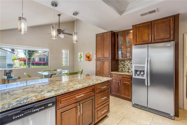 kitchen with appliances with stainless steel finishes, brown cabinets, visible vents, and decorative light fixtures