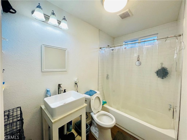 bathroom with toilet, a sink, visible vents, and shower / bath combination with curtain