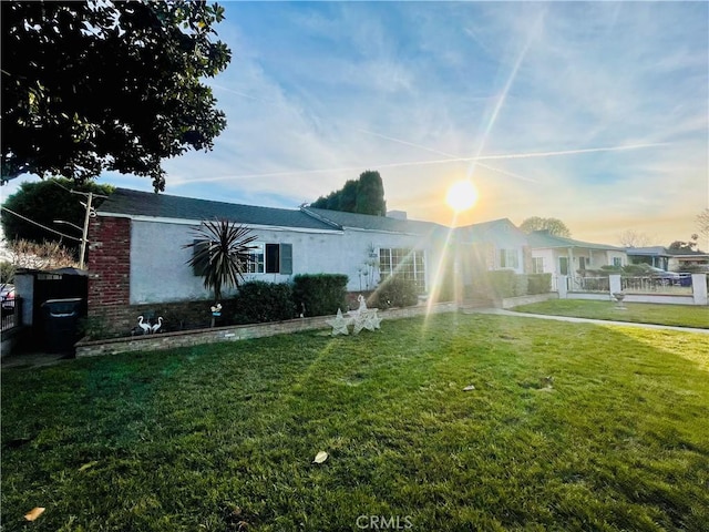 view of front of property with a lawn and stucco siding