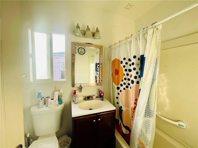 bathroom featuring toilet, shower / bathtub combination with curtain, and vanity