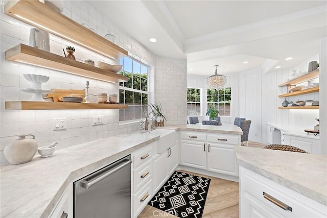 kitchen with light stone counters, white cabinets, stainless steel dishwasher, open shelves, and pendant lighting