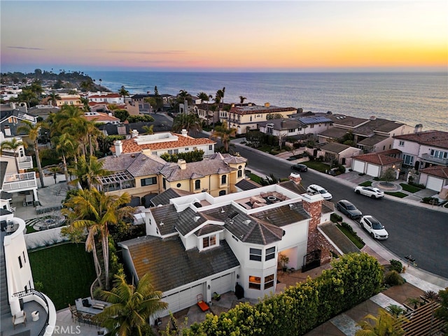 drone / aerial view featuring a water view and a residential view