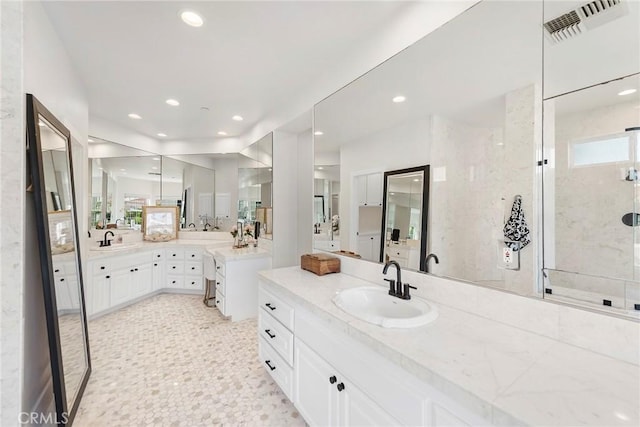 bathroom with vanity, visible vents, and recessed lighting