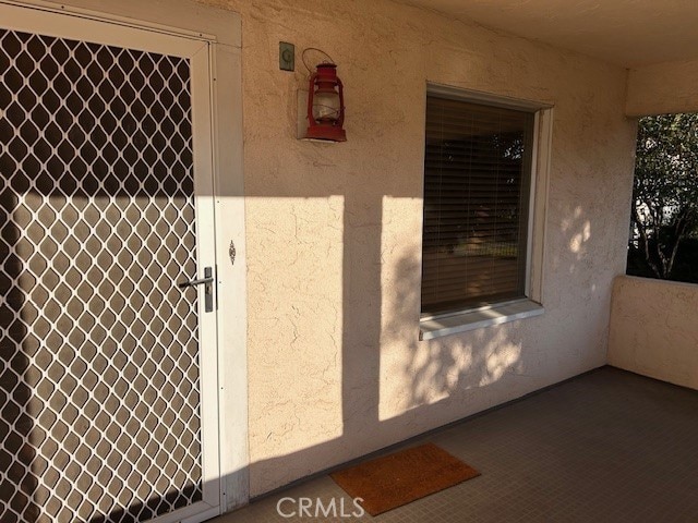 entrance to property featuring stucco siding