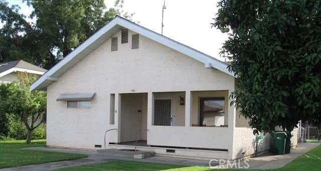 bungalow-style house with stucco siding