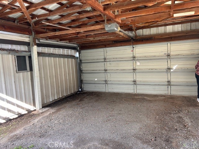 garage with metal wall and a garage door opener