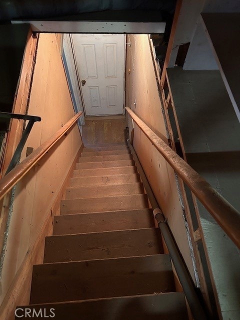 stairway with wood finished floors