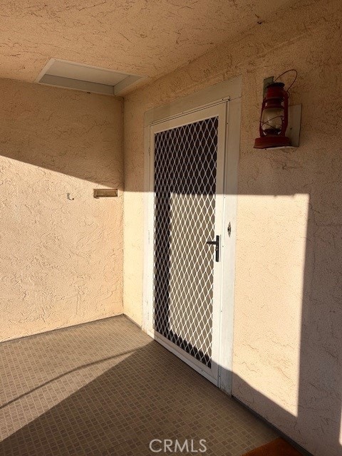 view of exterior entry featuring stucco siding