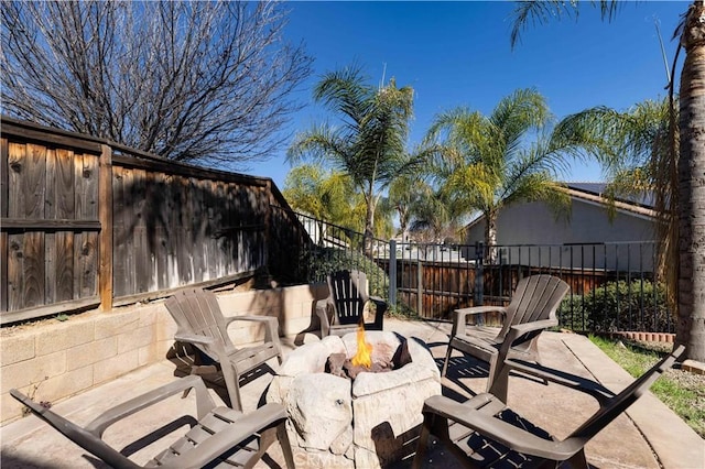 view of patio with fence and a fire pit