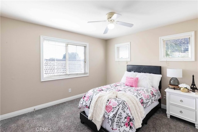 bedroom with dark carpet, a ceiling fan, and baseboards