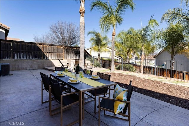 view of patio featuring outdoor dining space and a fenced backyard