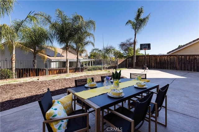 view of patio with outdoor dining space and a fenced backyard