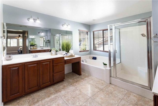 bathroom with a garden tub, a shower stall, tile patterned flooring, and vanity