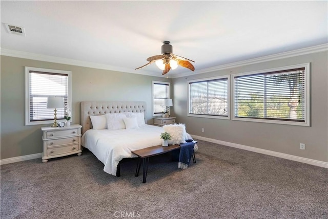 bedroom featuring baseboards, dark colored carpet, visible vents, and crown molding