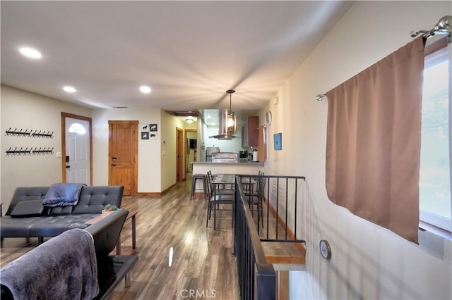 living area with recessed lighting, baseboards, and wood finished floors