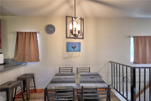 dining area featuring wood finished floors and a notable chandelier