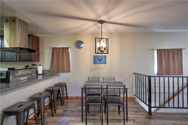 dining area with wood finished floors and baseboards