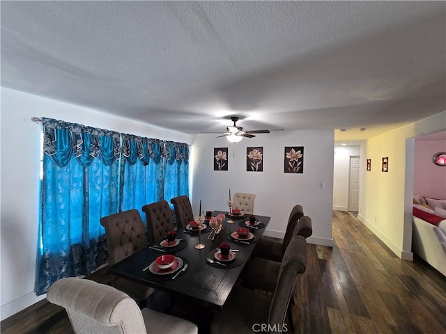 dining space with a ceiling fan, dark wood-style flooring, a textured ceiling, and baseboards