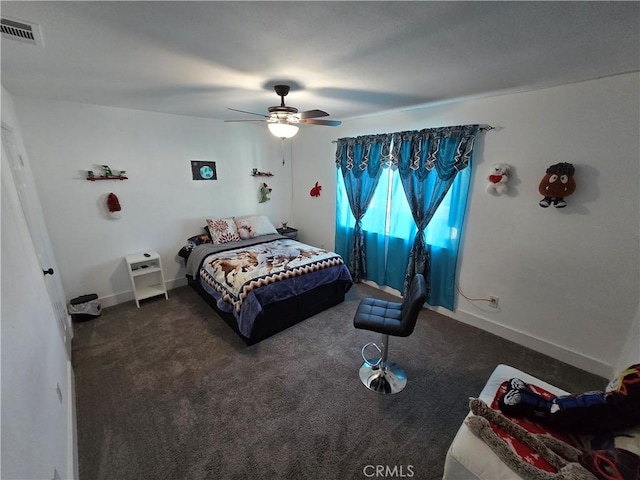 bedroom featuring a ceiling fan, dark colored carpet, visible vents, and baseboards