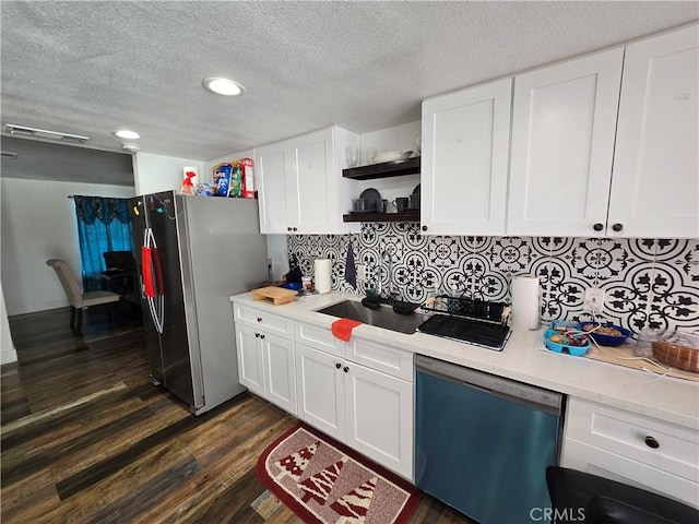 kitchen featuring white cabinetry, light countertops, appliances with stainless steel finishes, decorative backsplash, and dark wood finished floors