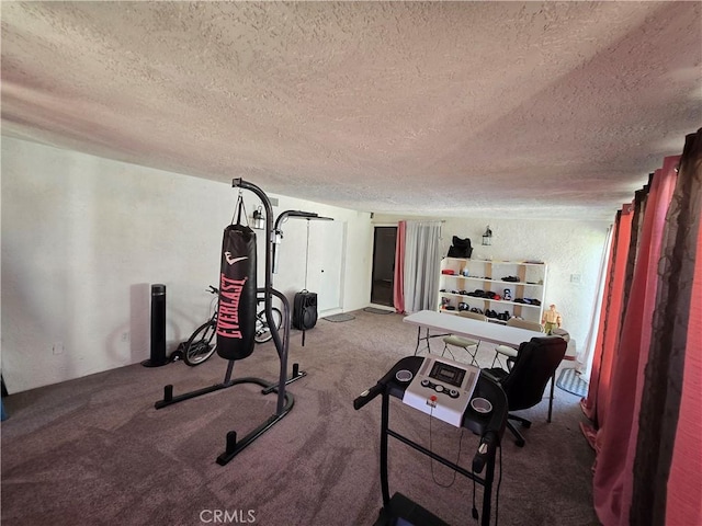 workout area featuring a textured ceiling and carpet