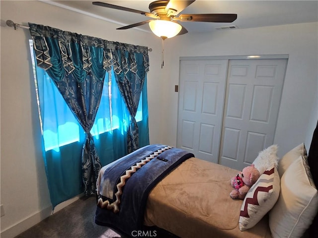 bedroom with visible vents, baseboards, ceiling fan, carpet, and a closet