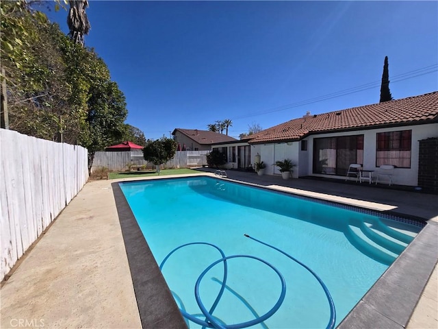 view of pool featuring a fenced in pool, a fenced backyard, and a patio