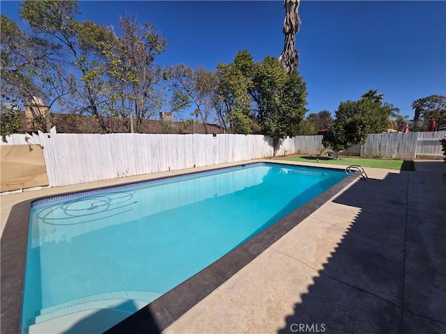 view of swimming pool with a fenced backyard, a fenced in pool, and a patio