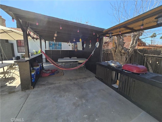 view of patio / terrace featuring a grill and fence