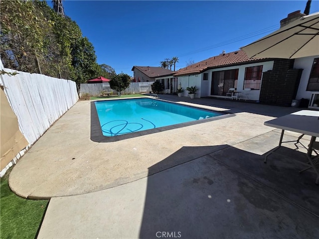 view of pool with a patio, a fenced backyard, and a fenced in pool