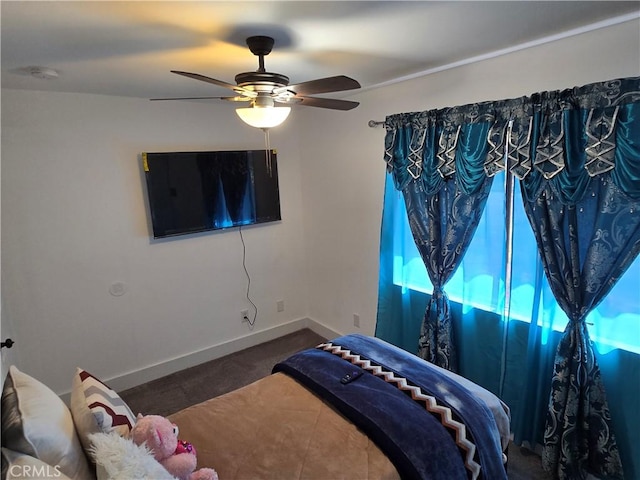 bedroom featuring ceiling fan and baseboards